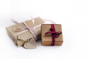 Two,Gift,Boxes,Tied,With,Ribbons,,Wooden,Carved,Heart,On