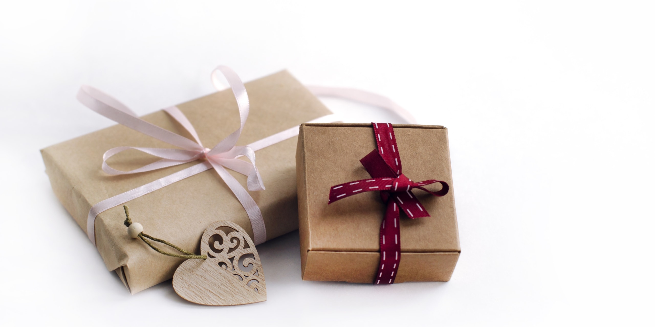 Two,Gift,Boxes,Tied,With,Ribbons,,Wooden,Carved,Heart,On